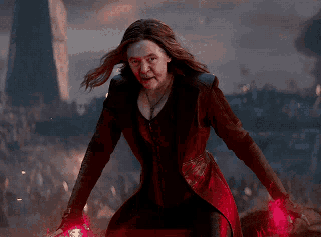a woman in a red coat holds a red object in her hands