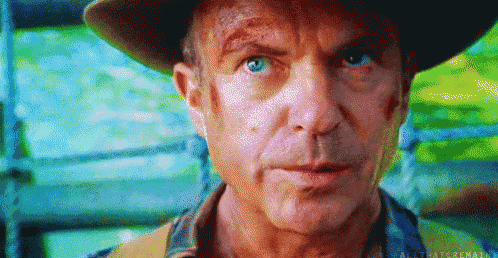 a close up of a man 's face wearing a hat and looking at the camera .