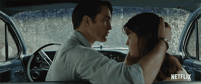 a man and woman in a car with netflix written on the bottom right