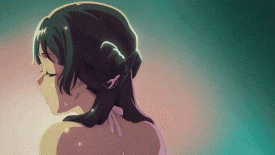 a close up of a woman 's back with a bun in her hair