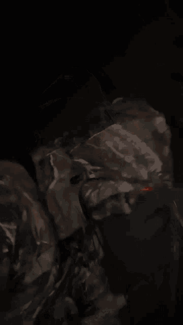 a close up of a person 's face with a black background
