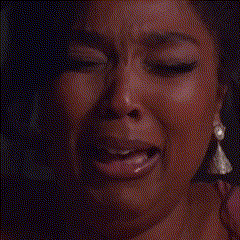 a close up of a woman 's face with tears coming down her face .