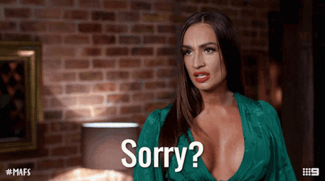 a woman in a green dress says " sorry "