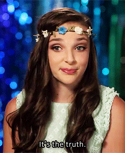 a young girl with a flower crown on her head says it 's the truth