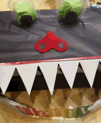 a shark 's mouth made out of triangles with a red heart on top of it