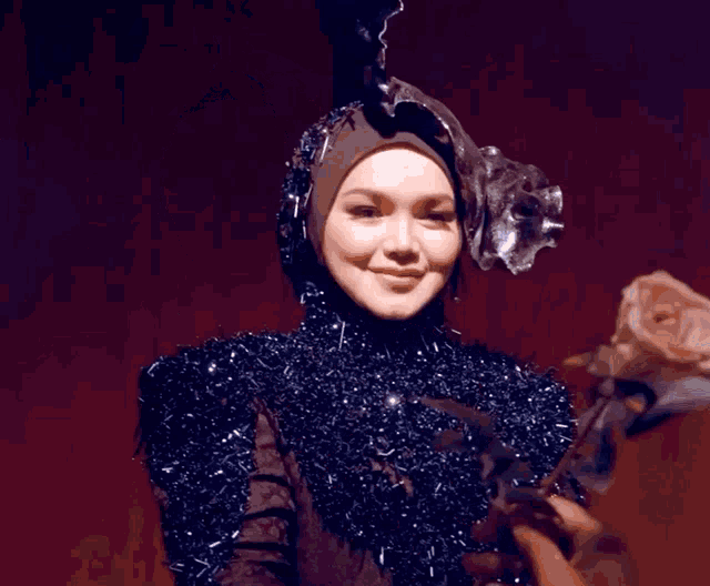 a woman with her eyes closed wearing a black costume