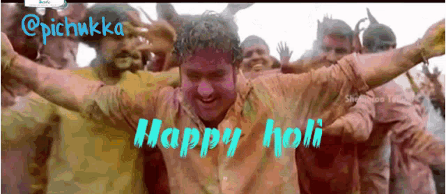 a group of people are celebrating holi with a man in the foreground
