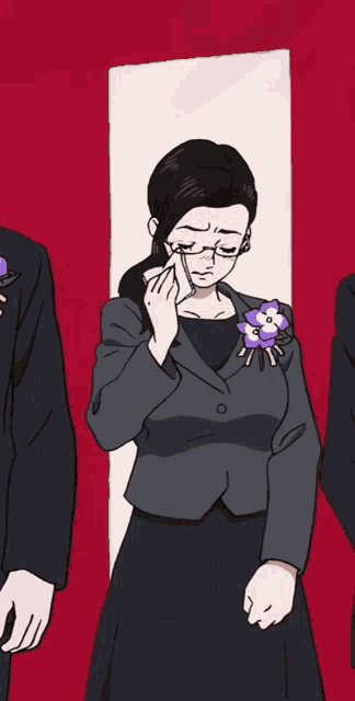 a woman in a suit with a flower on her lapel