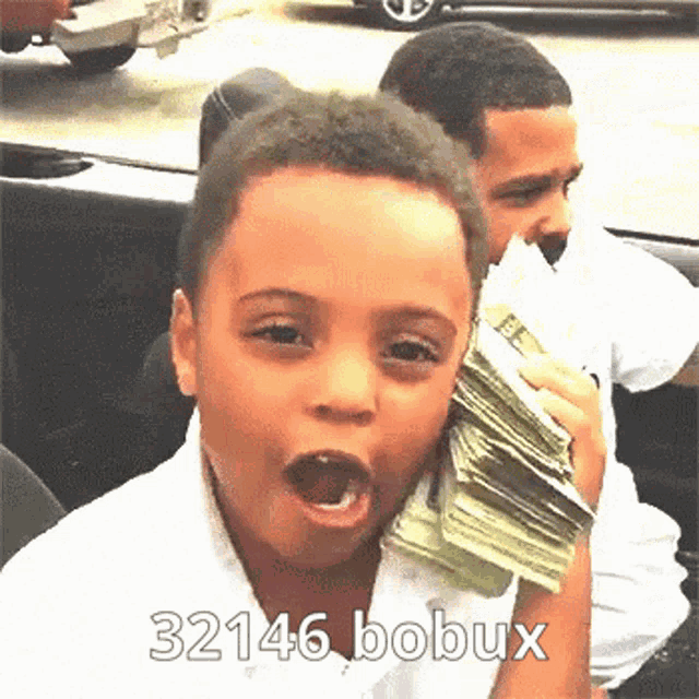 a young boy is holding a stack of money with the number 32146 bobux written below him