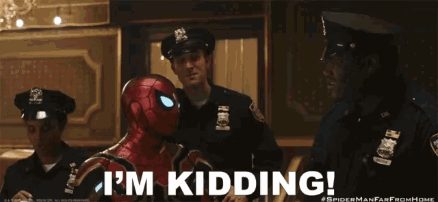 a man in a spider man suit says i 'm kidding in front of two police officers
