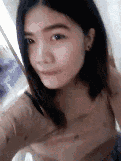 a close up of a woman taking a selfie with a blurred background .