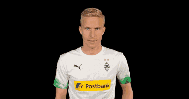 a man wearing a white shirt with a yellow stripe that says postbank on it