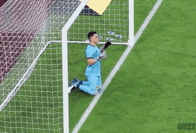 a soccer player kneeling in front of a goal with gif22 written below him