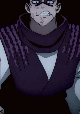 a man with a scarf around his neck and a purple vest