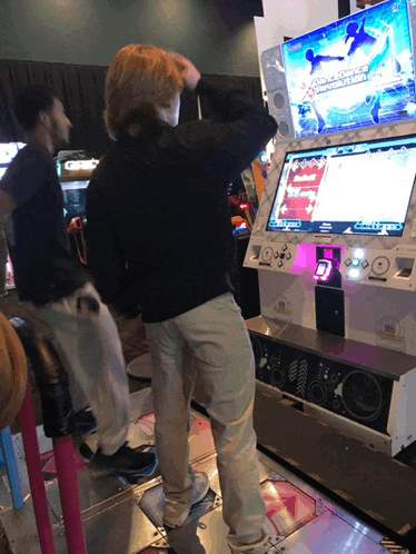 a man playing a video game with a screen that says dance dance dance