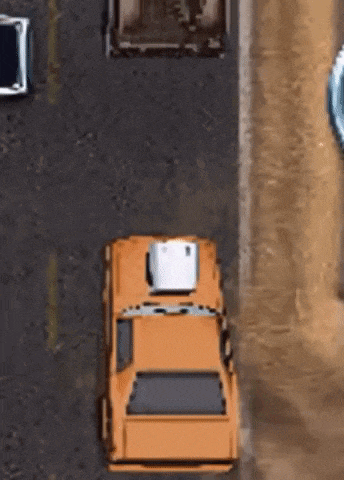 an aerial view of an orange car with a white box on top of it driving down a road .