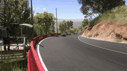 a car is going down a road with a red barrier