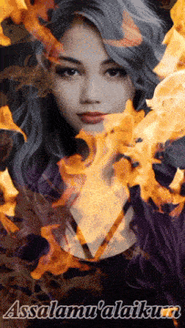 a woman is surrounded by flames and the words " asalamu 'alaikum "