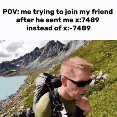 a man wearing sunglasses and a backpack is walking on a mountain .