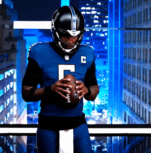 a football player wearing a blue uniform with the letter c on it