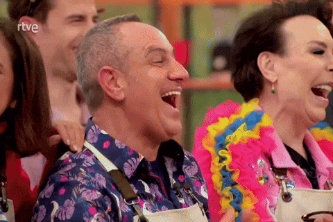 a group of people are laughing in front of a screen that says rtve on it