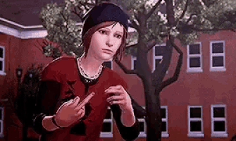 a woman in a red shirt and black hat is giving the middle finger .