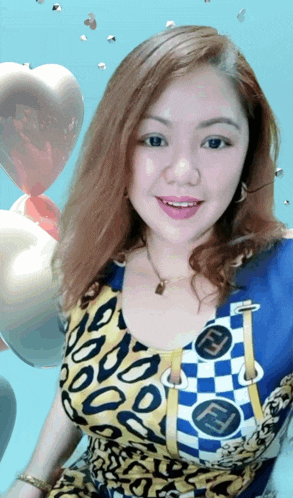 a woman in a blue and yellow top with a fendi logo on it