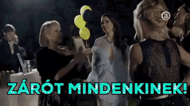 a group of women are standing in front of a sign that says zarot mindenkinek