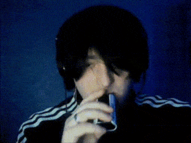 a person in a black and white striped jacket is surrounded by smoke .