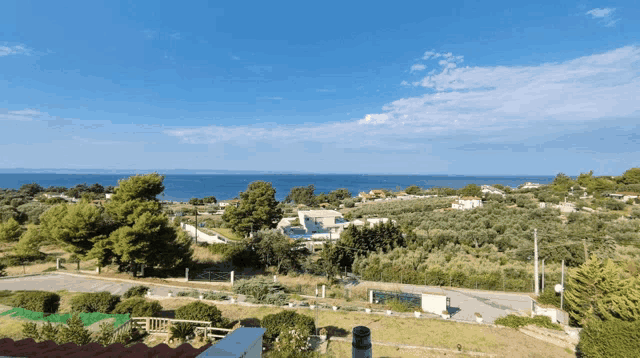 a view of the ocean from a rooftop with a chimney in the foreground