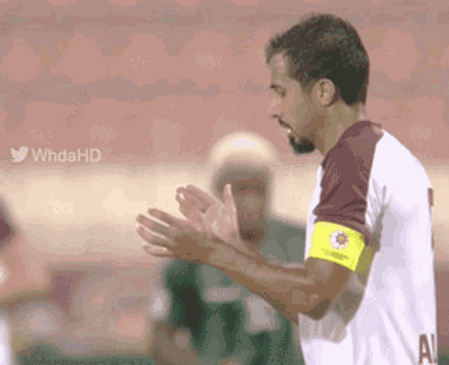 a soccer player wearing a white shirt with the letter a on it