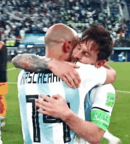 two soccer players are hugging each other and one has the number 11 on his shirt