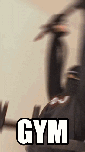 a blurred image of a person lifting a barbell with the word gym written below it