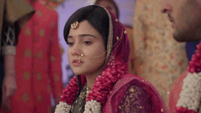 a woman wearing a nose ring and a veil