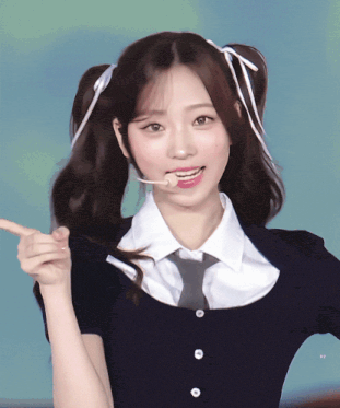 a girl with pigtails is wearing a tie and a shirt