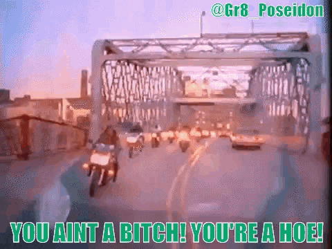 a person riding a motorcycle under a bridge with a caption that says you ain t a bitch