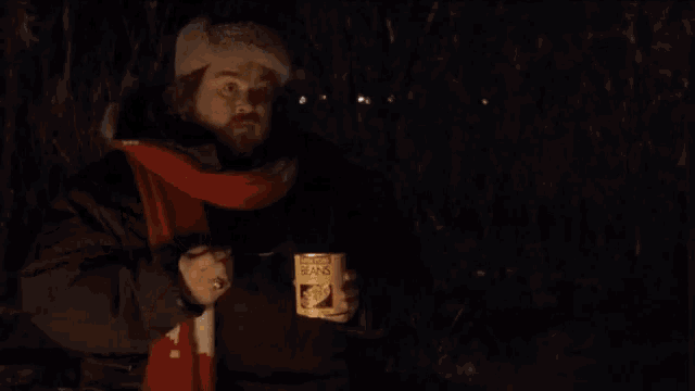 a man holding a can of beans with the words that was a cool movie above him