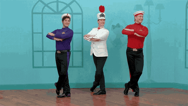 three men are standing next to each other with their arms crossed and one of them is wearing a wiggle shirt