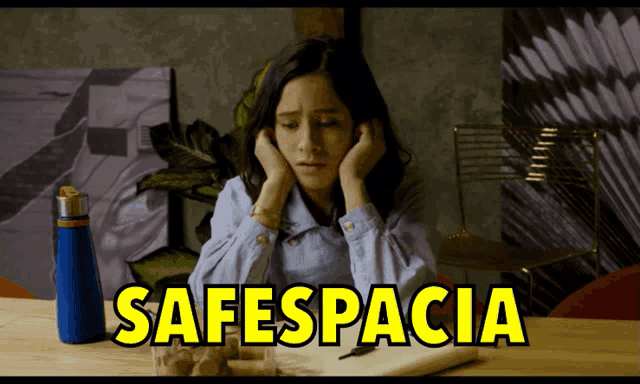 a woman sits at a table with the word safespacioa written on the bottom