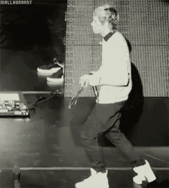 a black and white photo of a man dancing with niallhorarst written in the corner