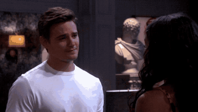 a man and a woman are looking at each other