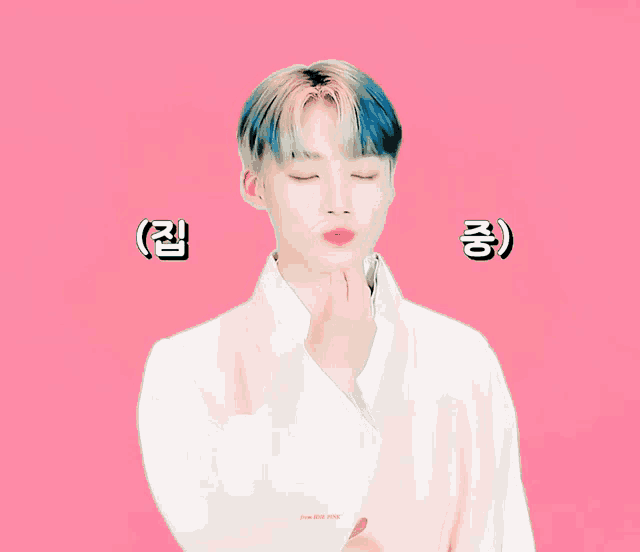 a boy with blue hair is wearing a white shirt and making a funny face