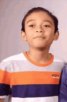 a young boy wearing a striped shirt with the word mony on the front
