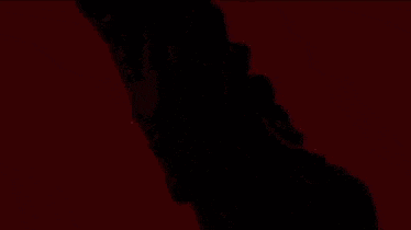a close up of a red and orange background with a blurred image of a person .