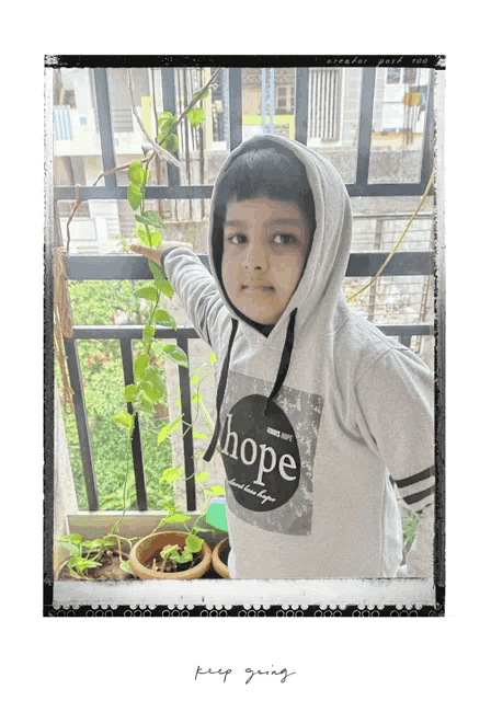 a boy wearing a hoodie that says hope