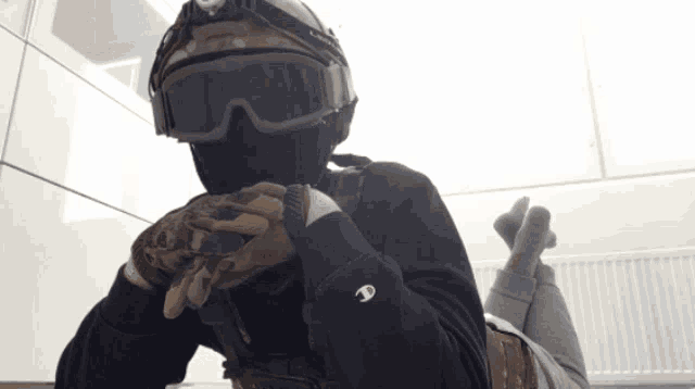 a person wearing a helmet and goggles is wearing a black champion sweatshirt