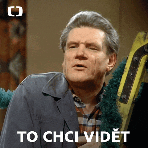 a man in a plaid shirt is standing next to a yellow ladder with the words " to chci vidět " on the bottom