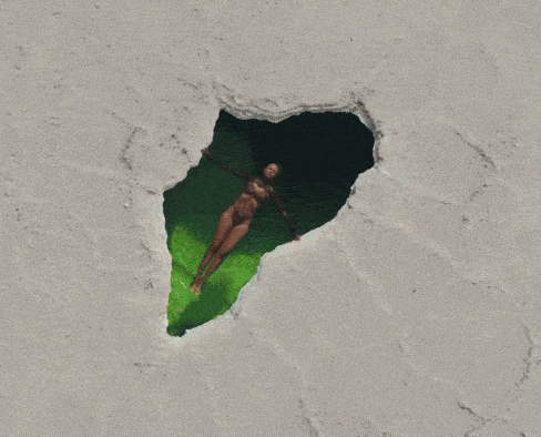 a woman in a bathing suit is laying on her back in the water
