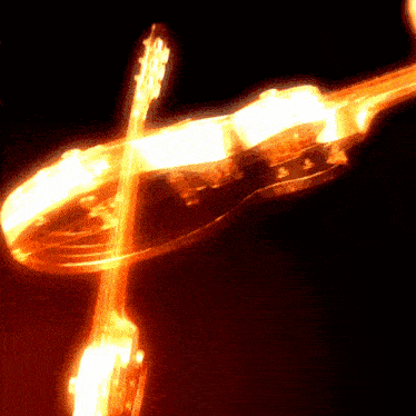 a blurred image of a violin and a banjo in a dark room
