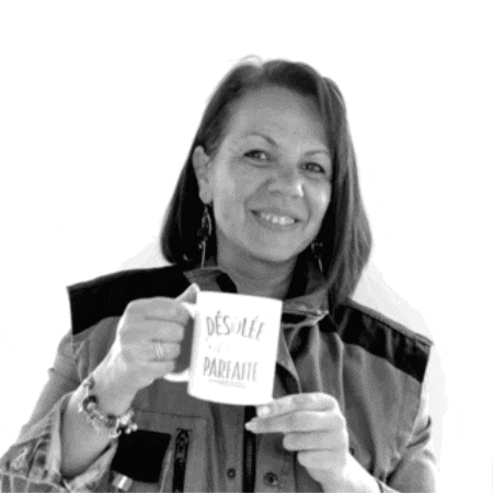 a woman is holding a coffee mug that says desillee